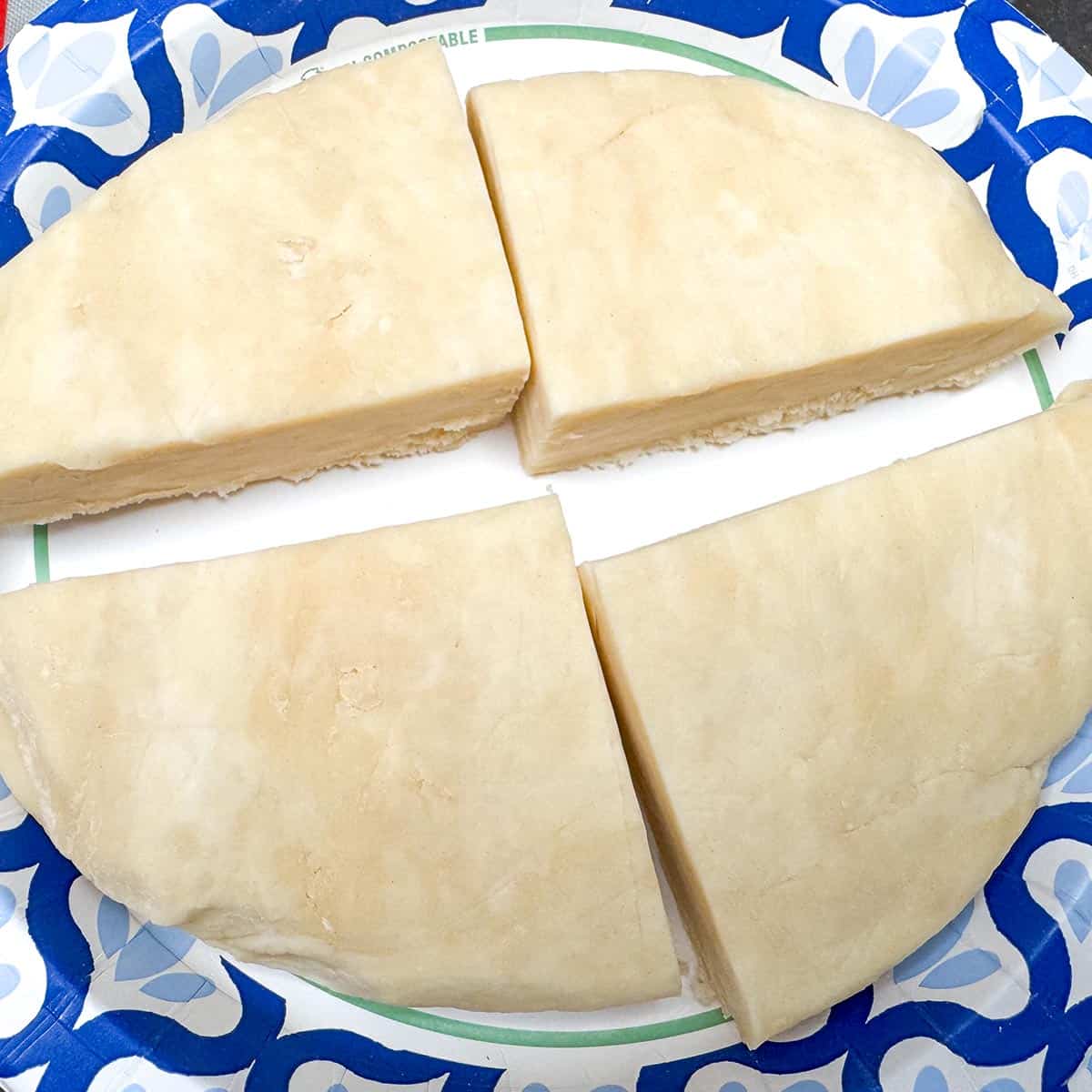 Chilled unwrapped cookie dough cut into quarters.