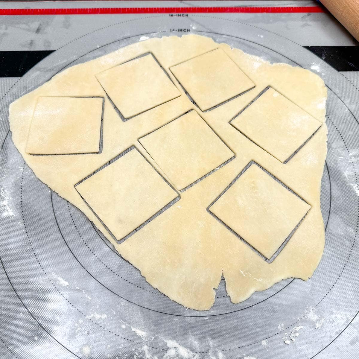 A quarter of the cookie dough rolled out and using the square cookie cutter have seven cutout.