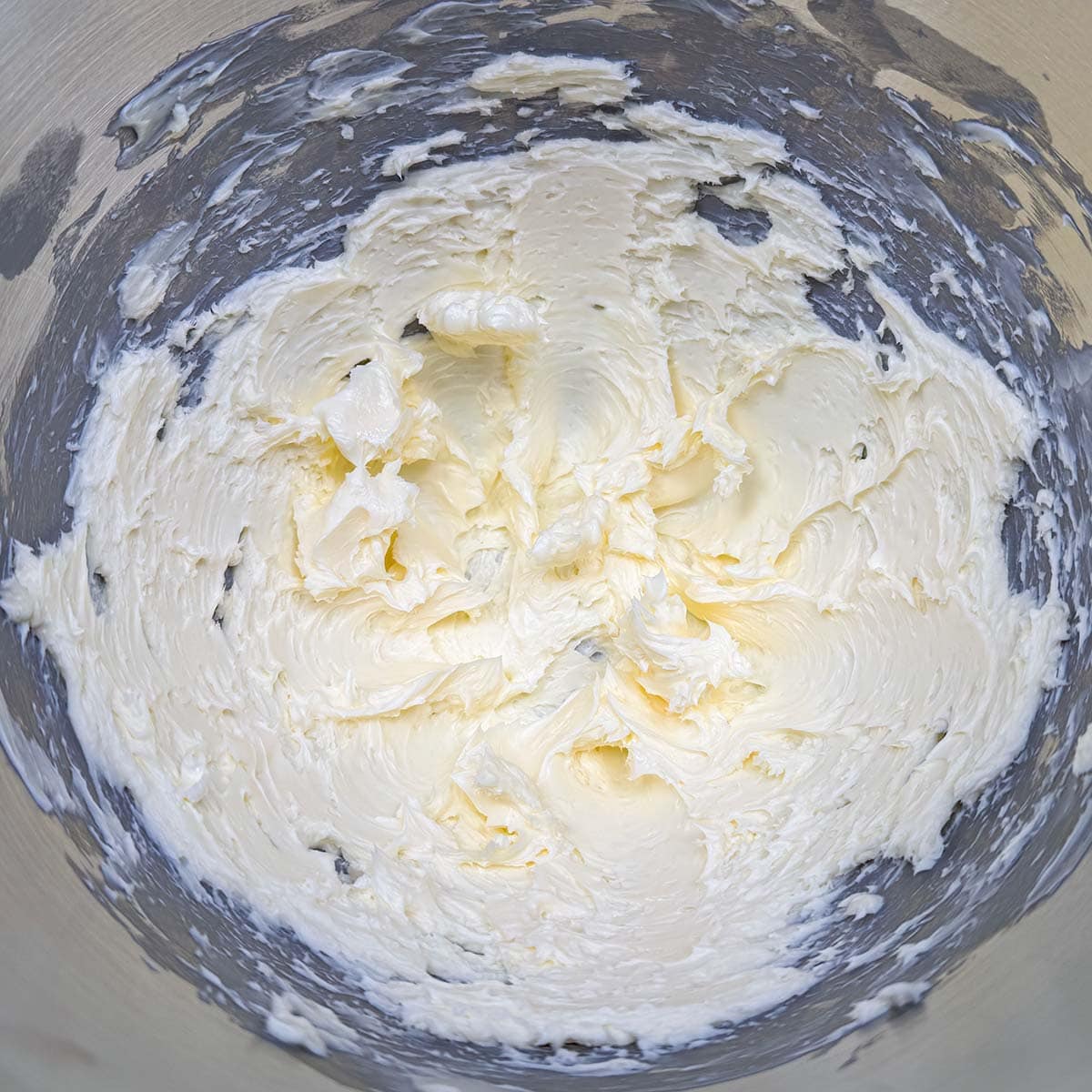 Creamed butter in a mixer bowl.