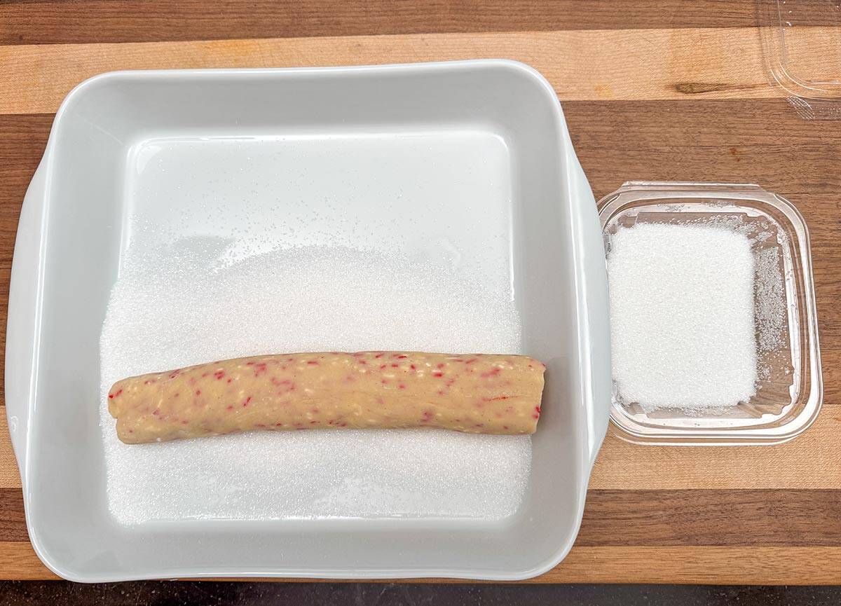 Rolling the cookie log in sanding or sparkling sugar in a dish.