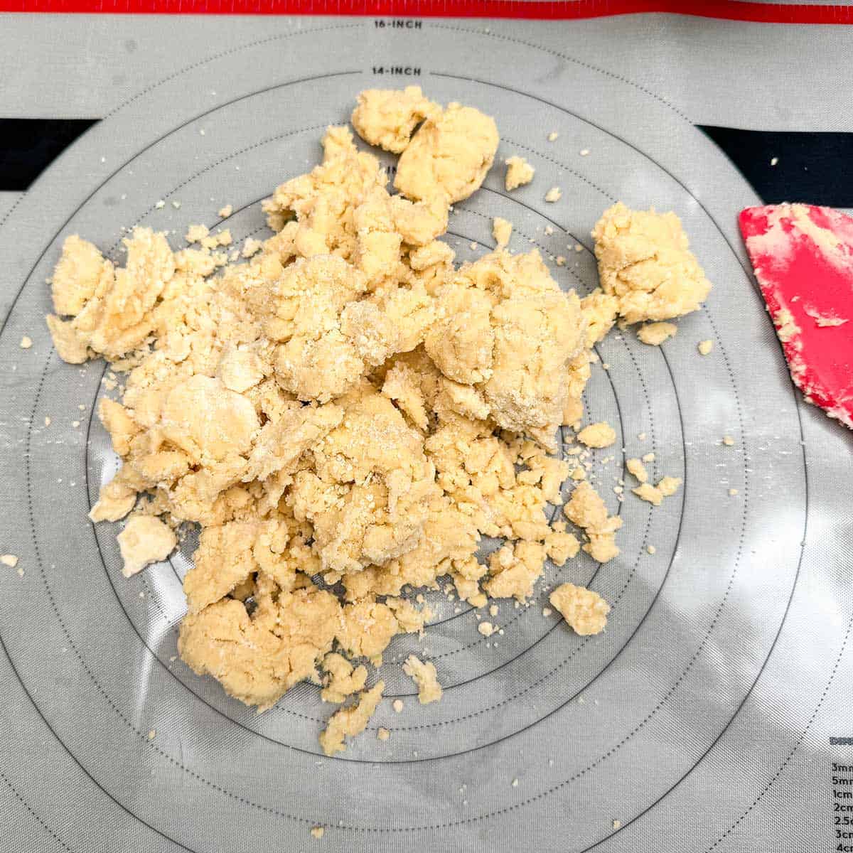 Cookie dough after the flour has been added in the mixer bowl. Now to finish by emptying the cookie onto a pastry mat and kneading the rest of the flour to be absorbed into the butter sugar mixture.