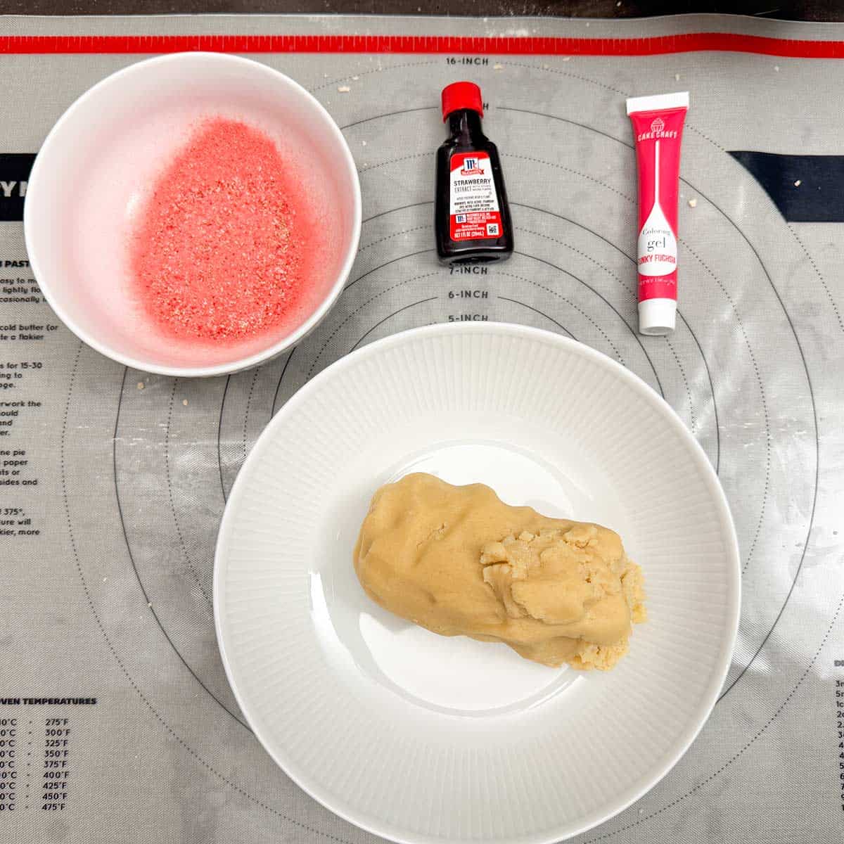 Cookie dough that has been divided in half and will have the freeze-dried strawberry powder, pink gel coloring , and the strawberry extract added.