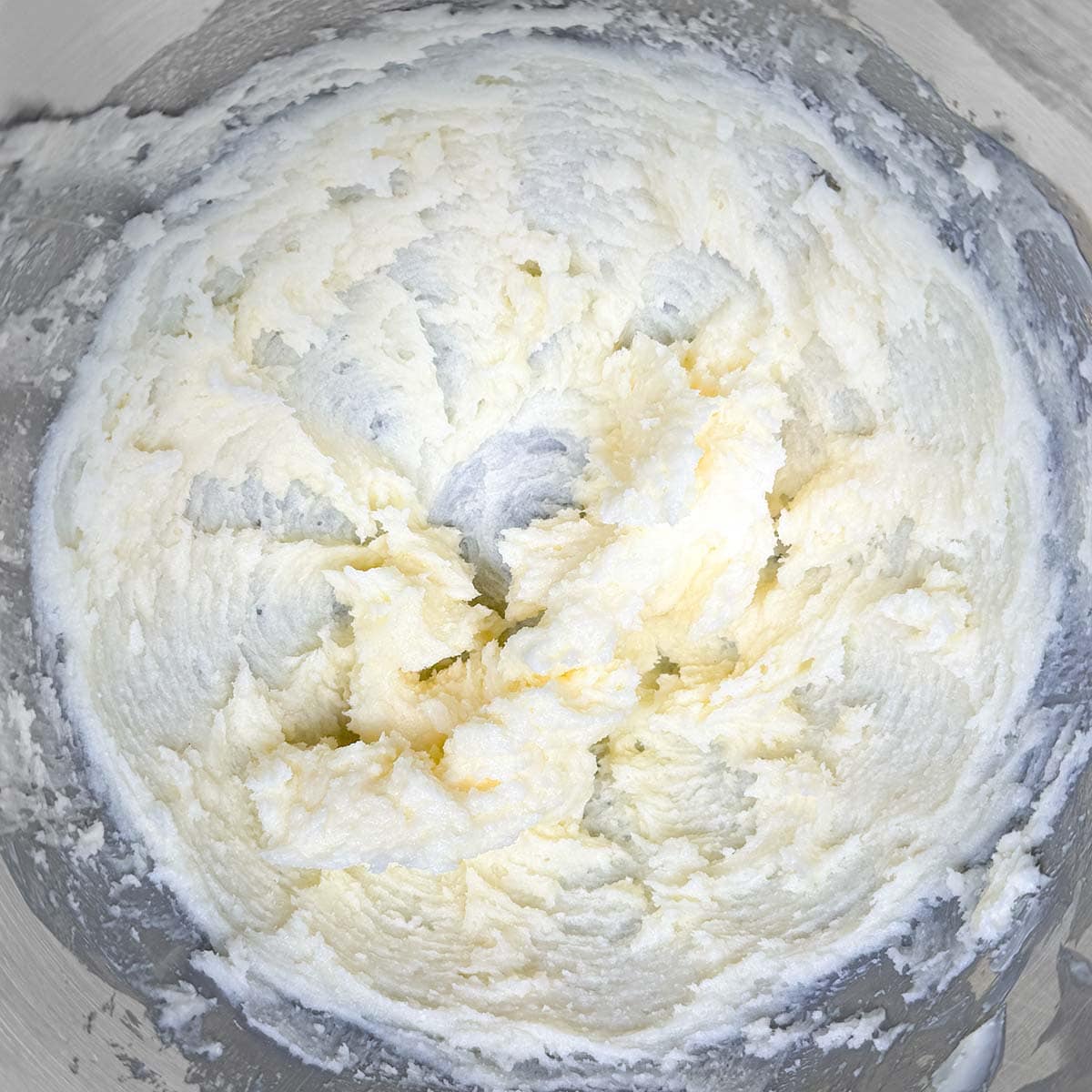Sugar and the creamed butter mixed for three minutes in a mixer bowl.