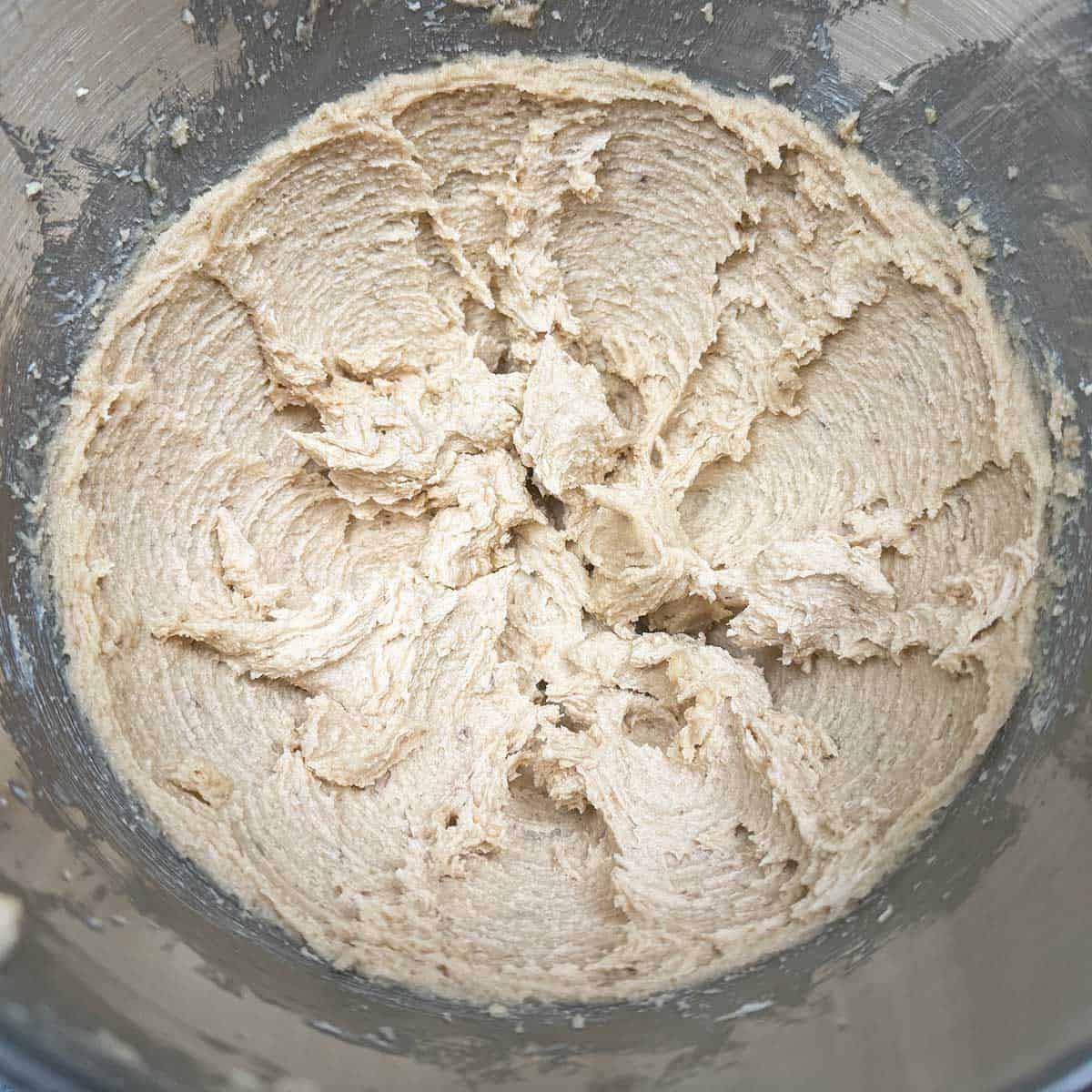 Butter and sugars after mixing for three minutes and have medium size peaks in the bowl.