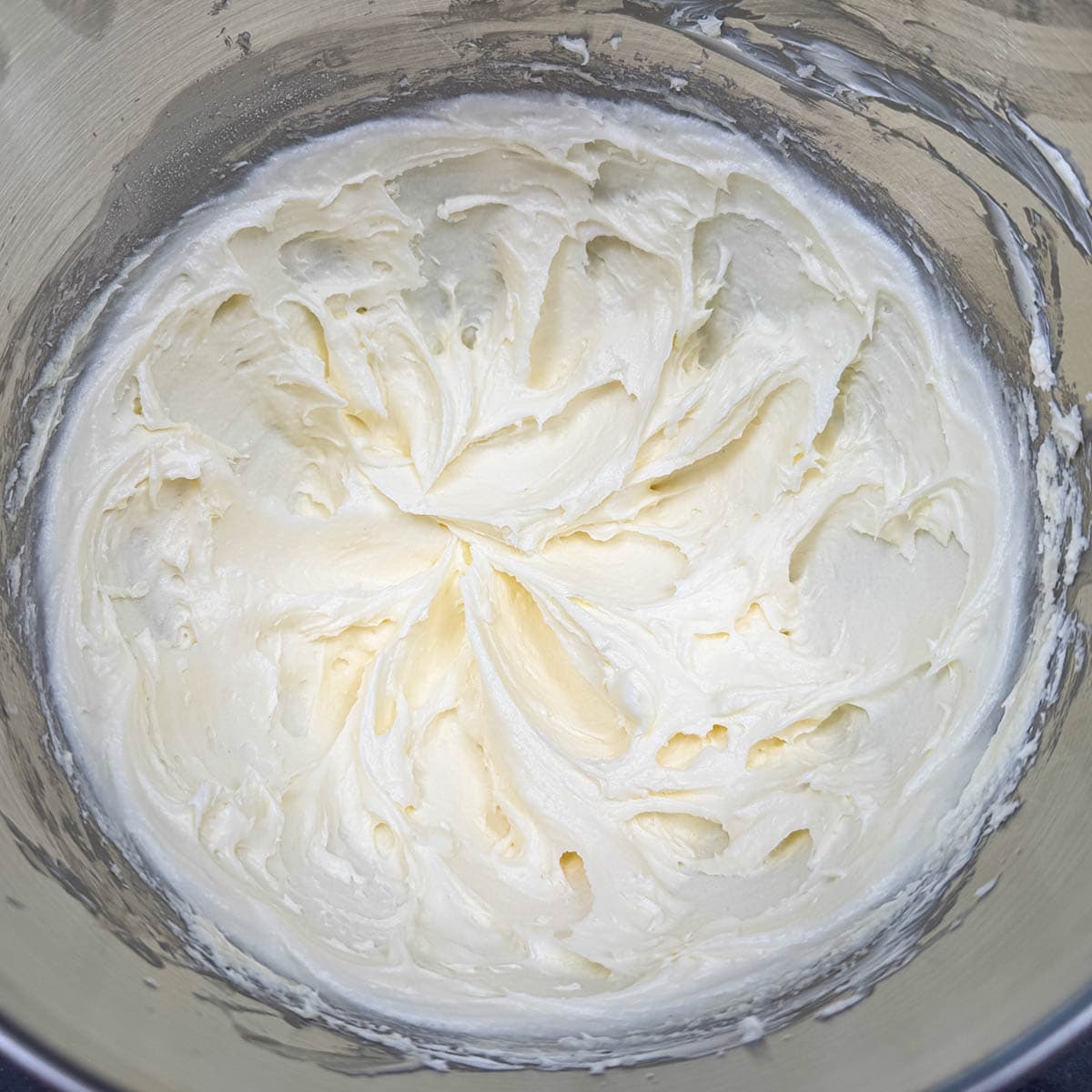 Cookie dough that has sugar, butter, and cream cheese mixed for three minutes to create soft swirls.