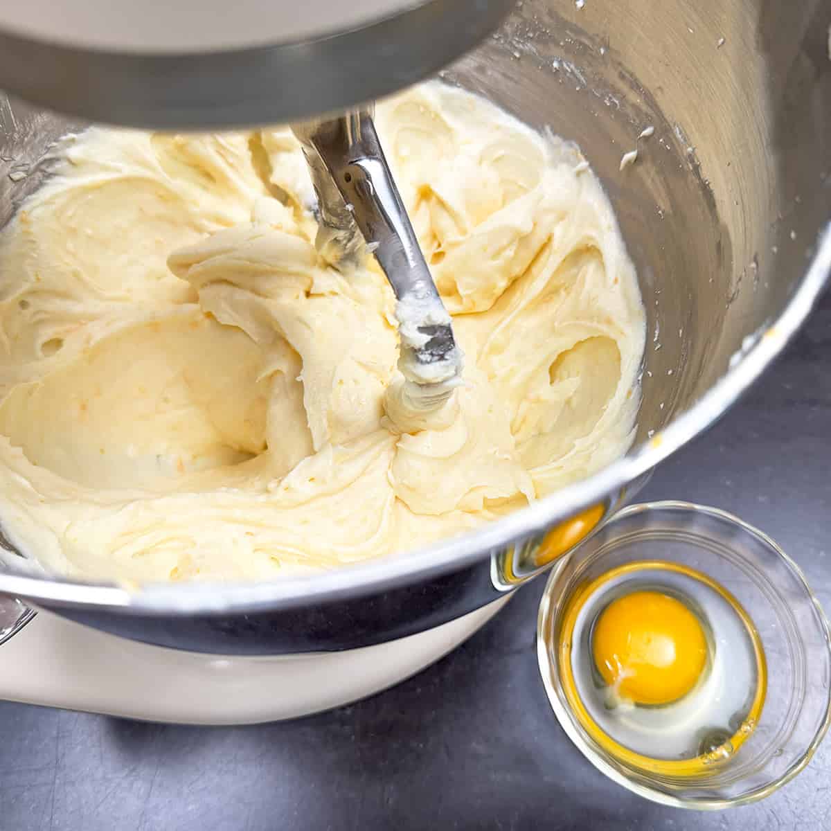 Adding the egg to the wet cookie dough.