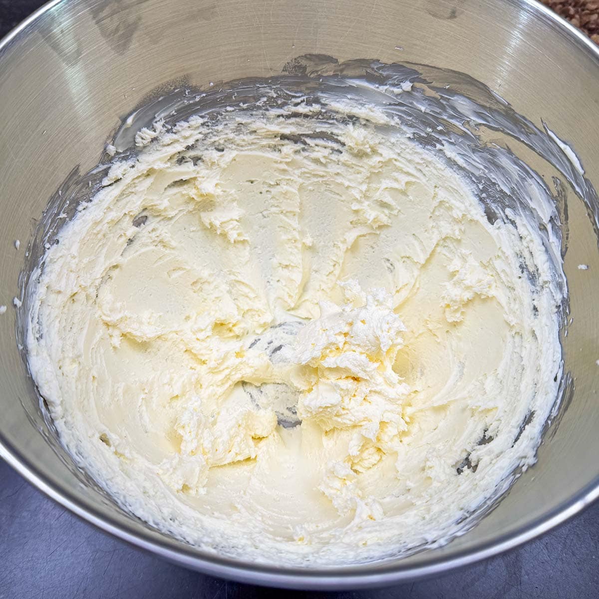 Cream cheese and butter that has been blended in a mixer bowl.