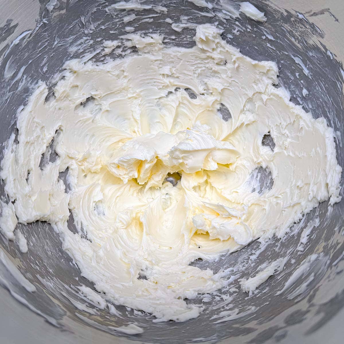 Creamed butter after it has been mixed with a mixer and has soft peaks.