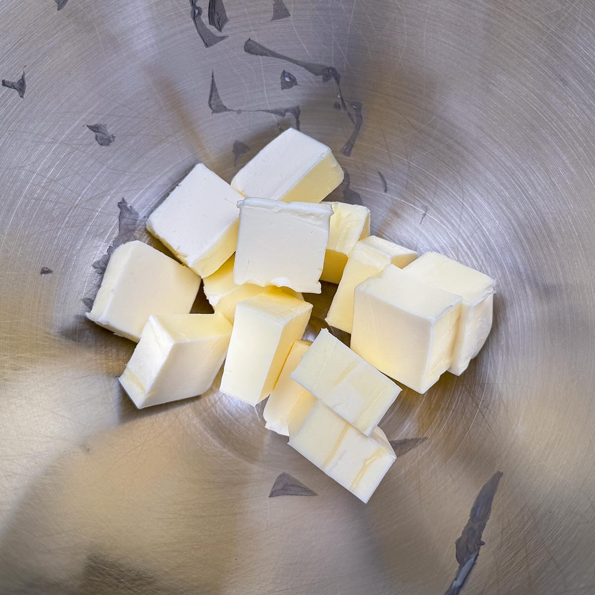 Cubed butter in a mixer bowl.
