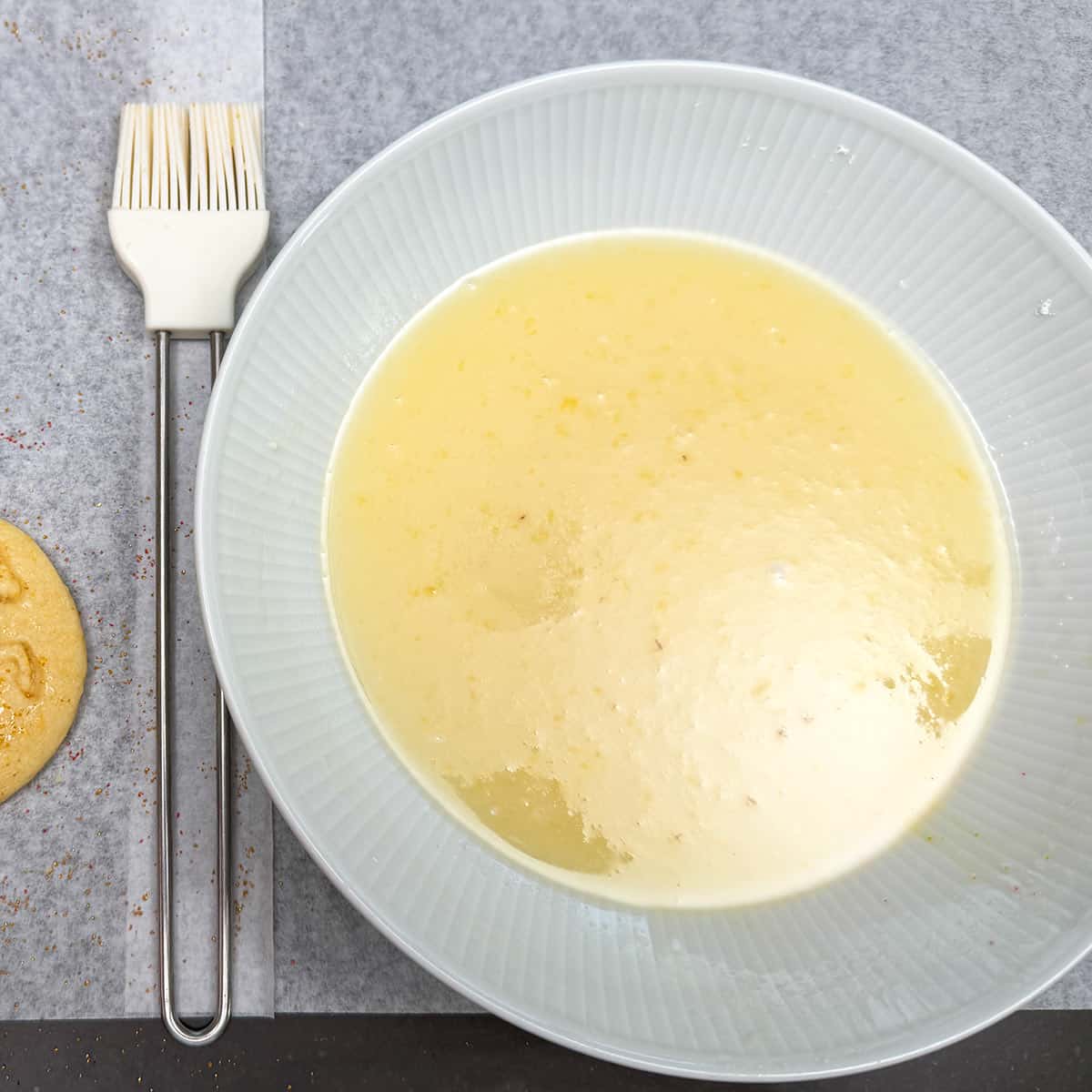 Thin glaze to be brushed onto the tops of the cookies to the gold sugar can be sprinkled on.