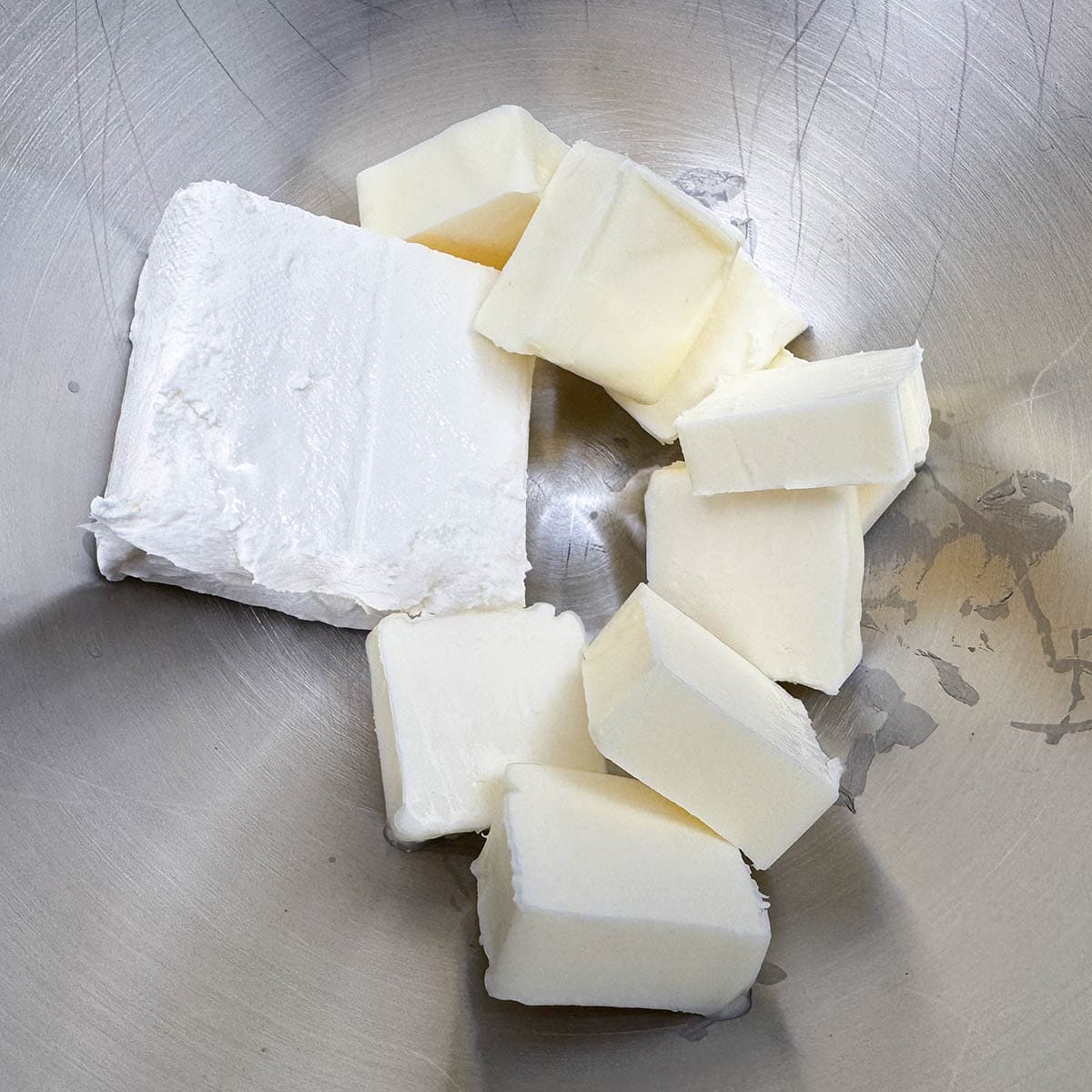 Cubed butter and cream cheese in a mixer bowl to be mixed for the icing.
