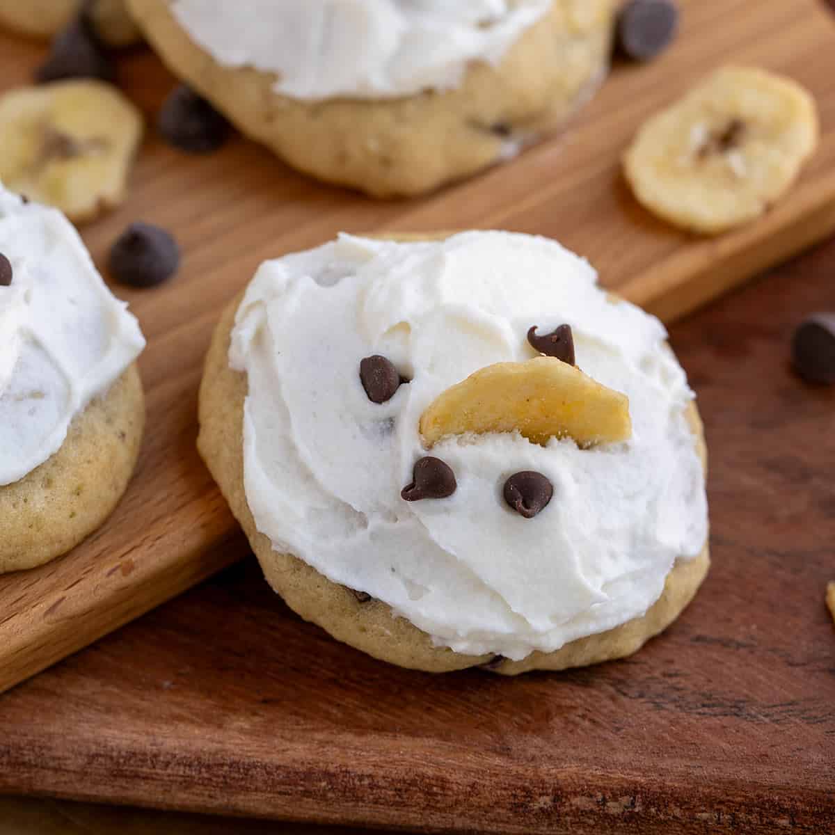 Banana Bread cookies with mini chocolate chips and a banana chip on top of the icing.