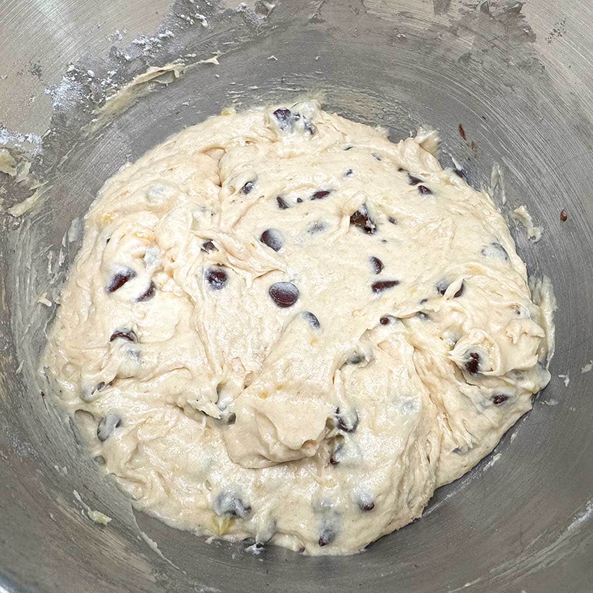 Soft cookie dough with chocolate chips getting ready to be chilled before baking.