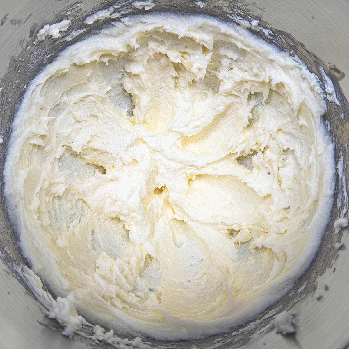 Cream cheese and butter and sugar that has been mixed for three minutes and now fluffy.