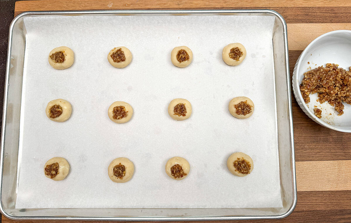 Cookie wells are filled with the walnut date filling.
