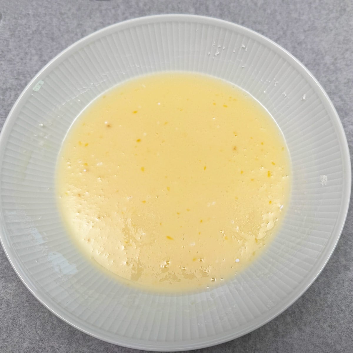 Honey orange glaze in a bowl ready to be added to the cookies.