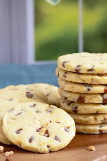 Featured Orange cinnamon chip sugar cookies on a wooden board.