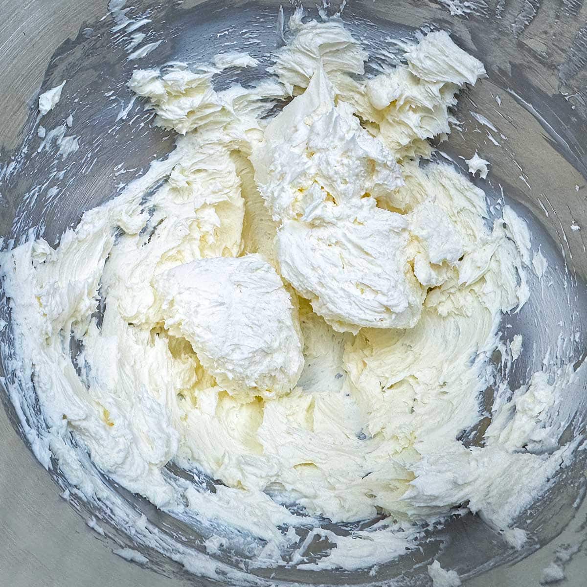Cream cheese and sugar that has been mixed into fluffy shaped clouds.