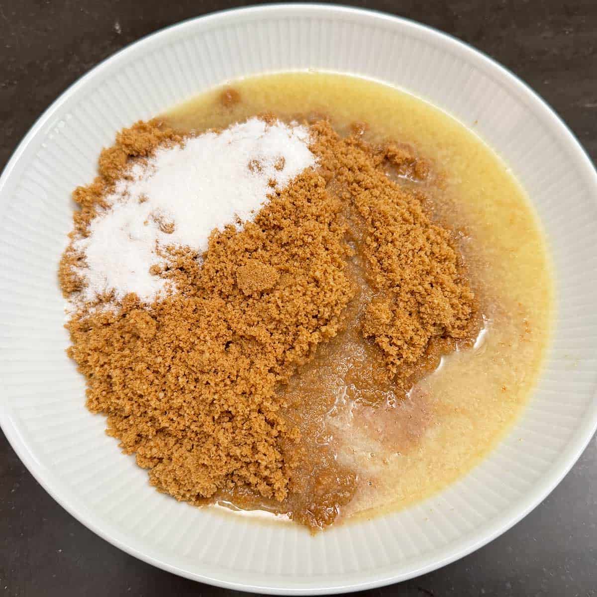Chopped grahams and nuts in a bowl with sugar and melted butter.