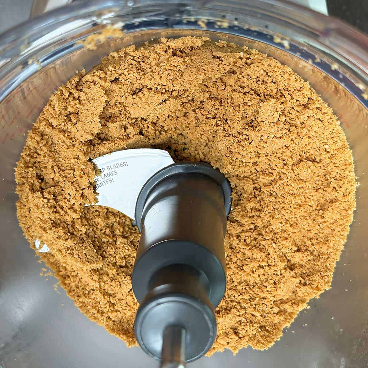 Macadamia nuts and the graham crackers that have been pulsed for the crust of the cheesecake.