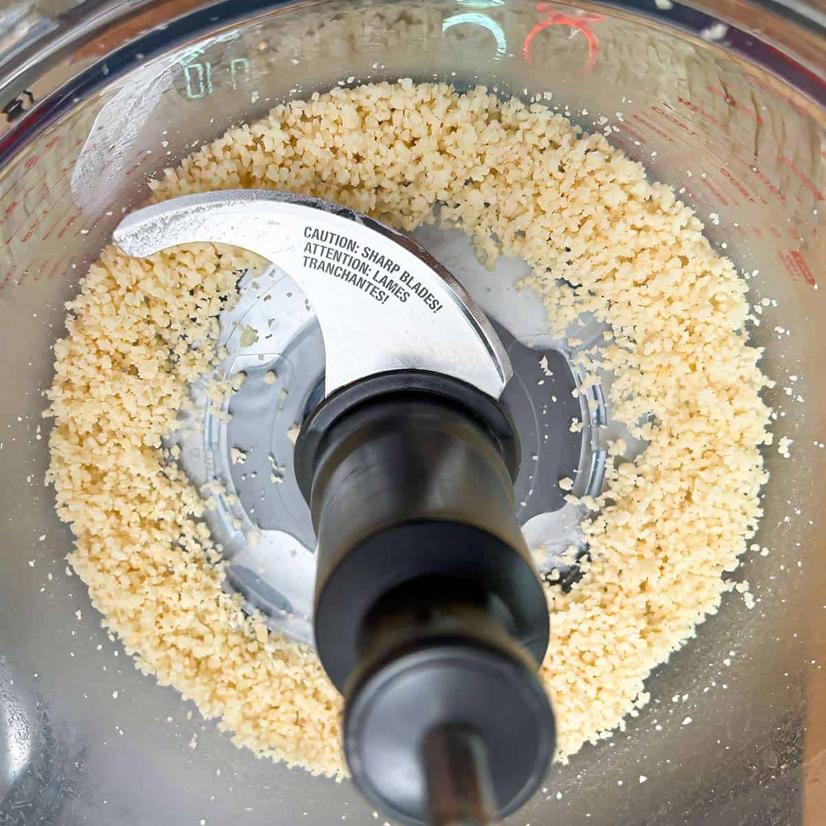 Small course grain size pieces of macadamia nuts done in a food processor.