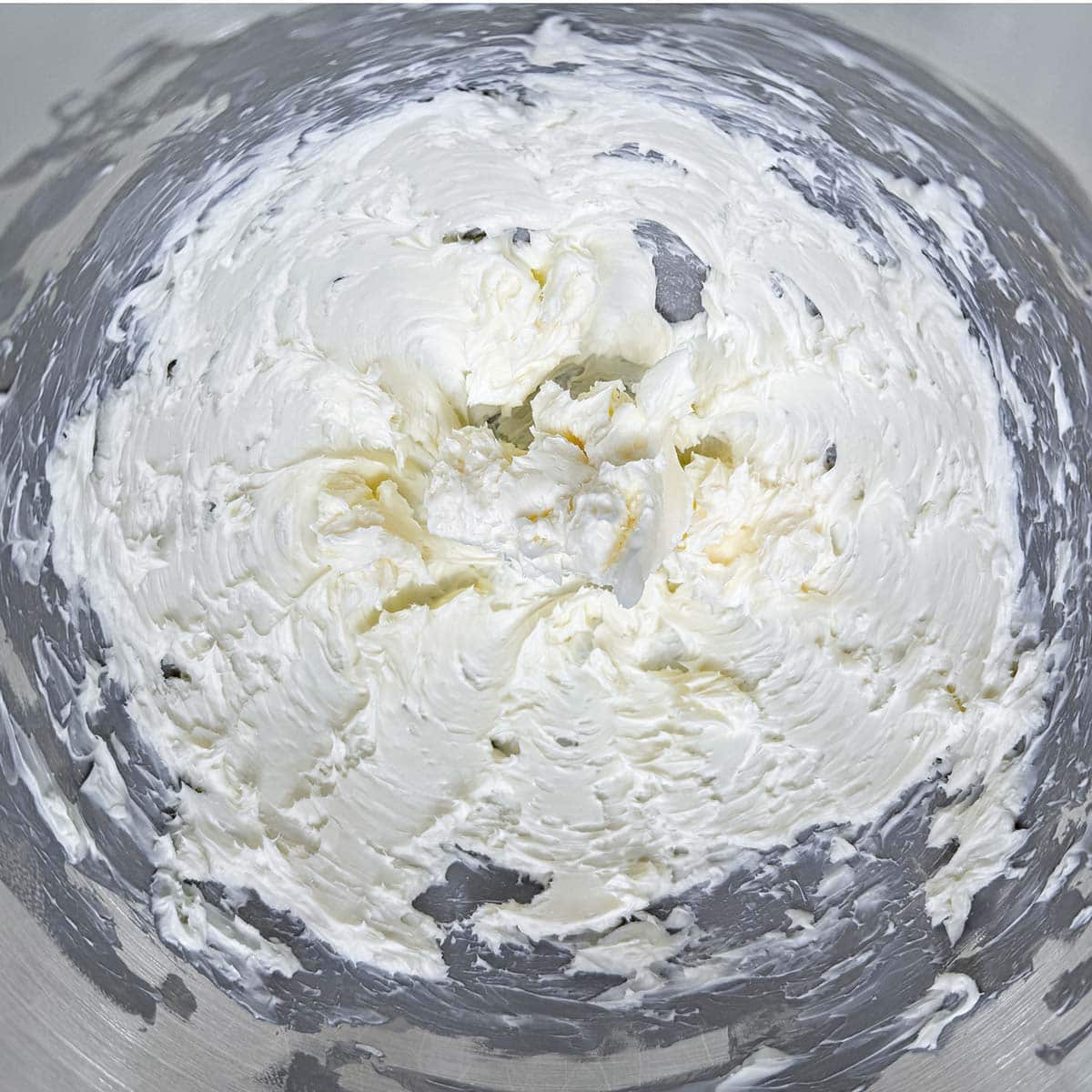 Creamed butter in a mixer bowl.