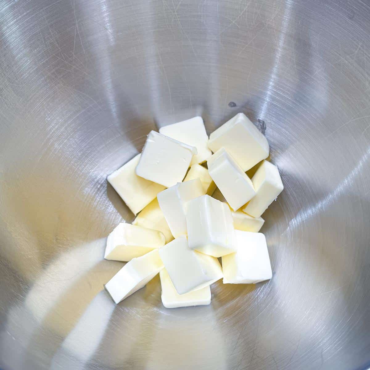 Cubed butter in a mixer bowl ready to be creamed.