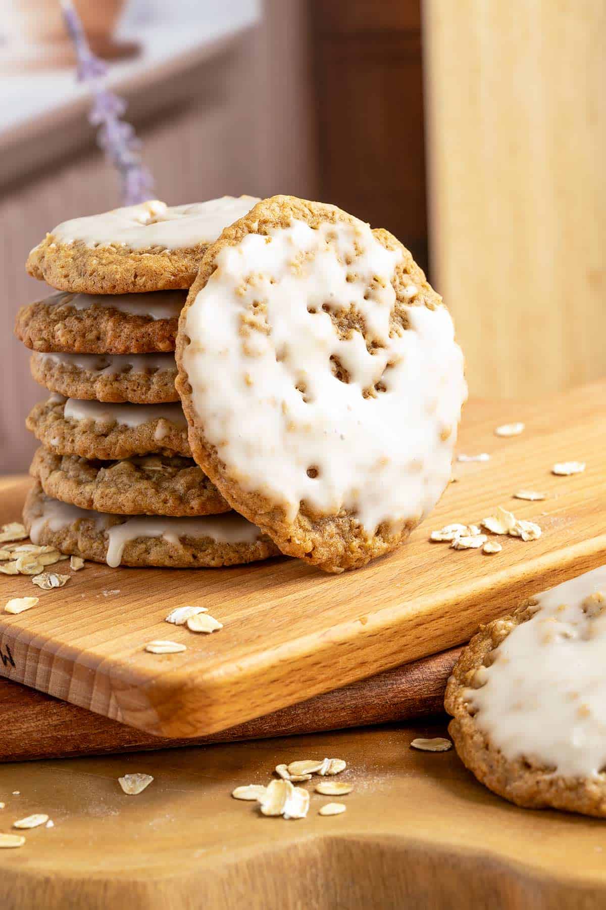 Maple cinnamon iced oatmeal cookies stacked with close up front view of the cookies texture.