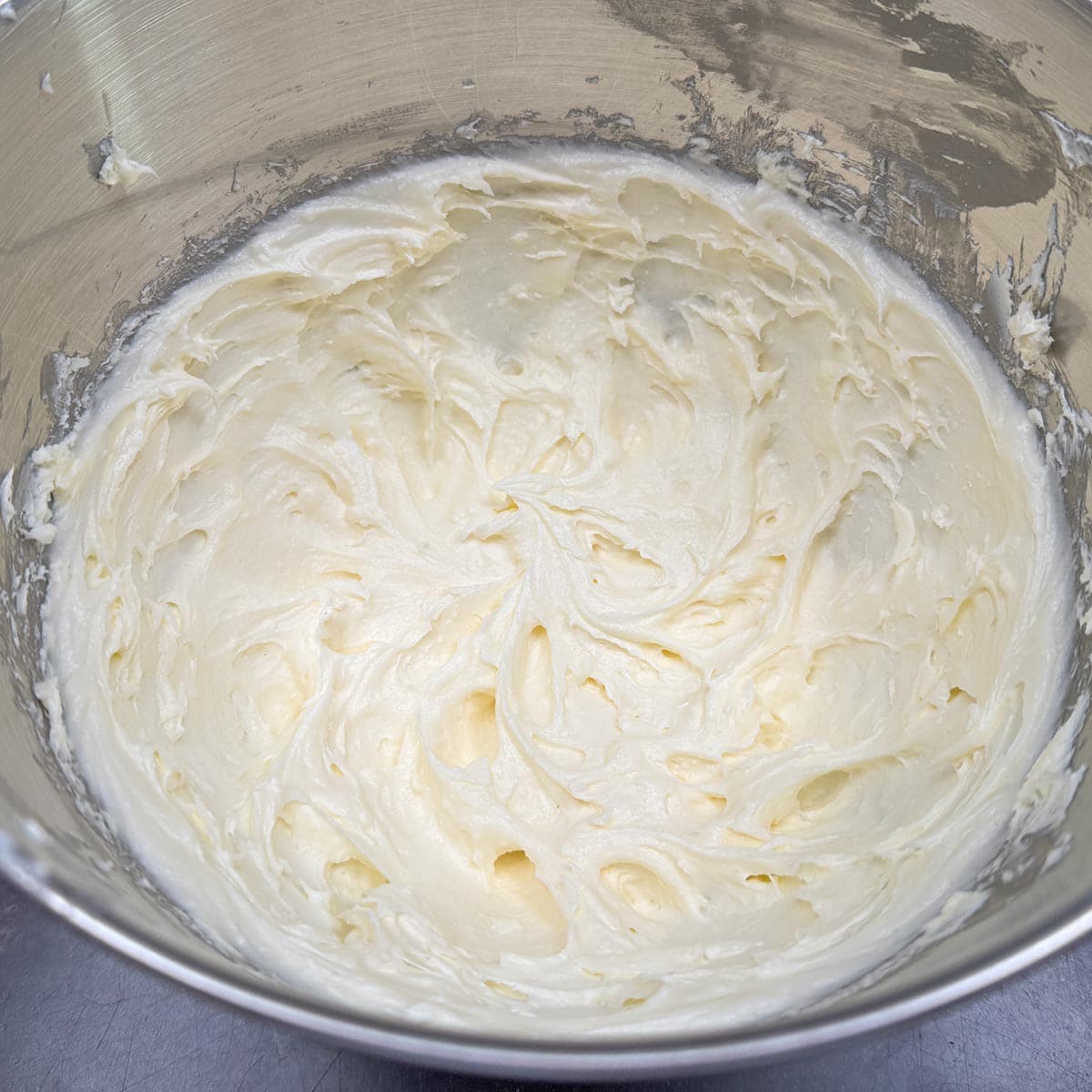 Cream cheese and butter mixed in a mixer bowl.