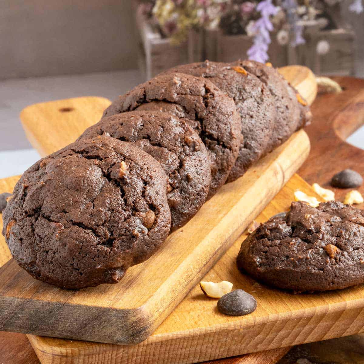 Chocolate hazelnut cookies with espresso on wooden cutting boards with no sprinkled powdered sugar on them.
