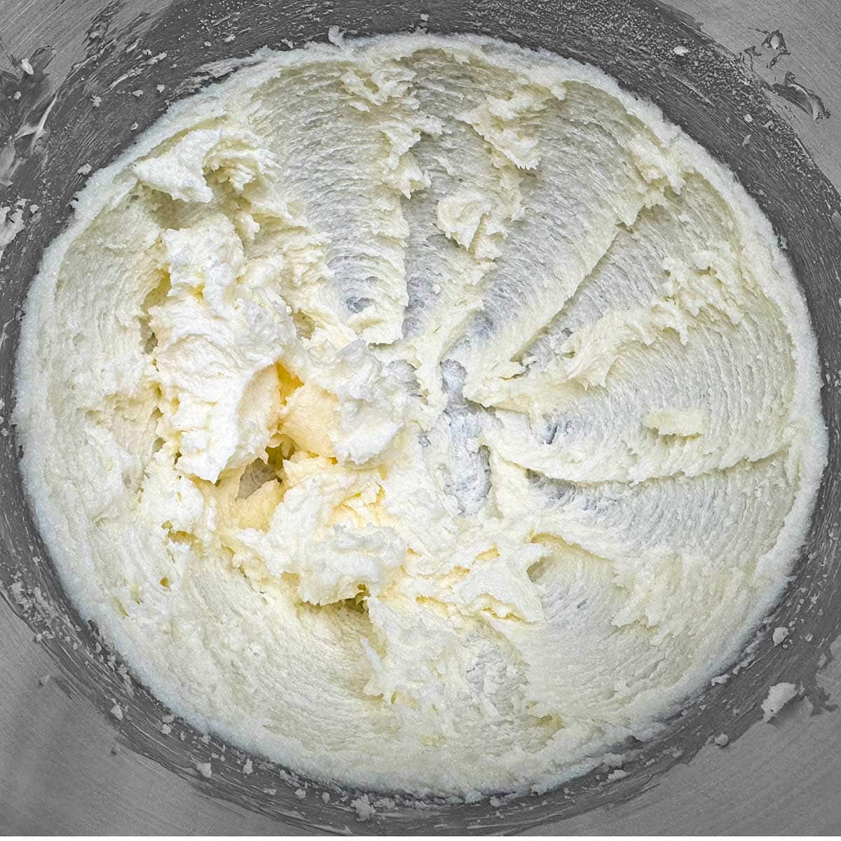 Creamed butter and sugar mixed for three minutes in a mixer bowl.