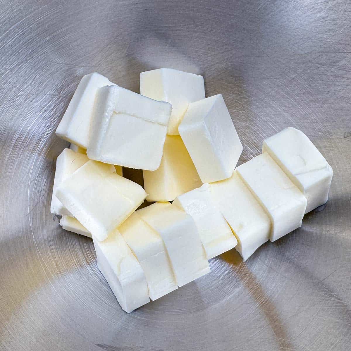 One cup of cubed butter in a mixer bowl.