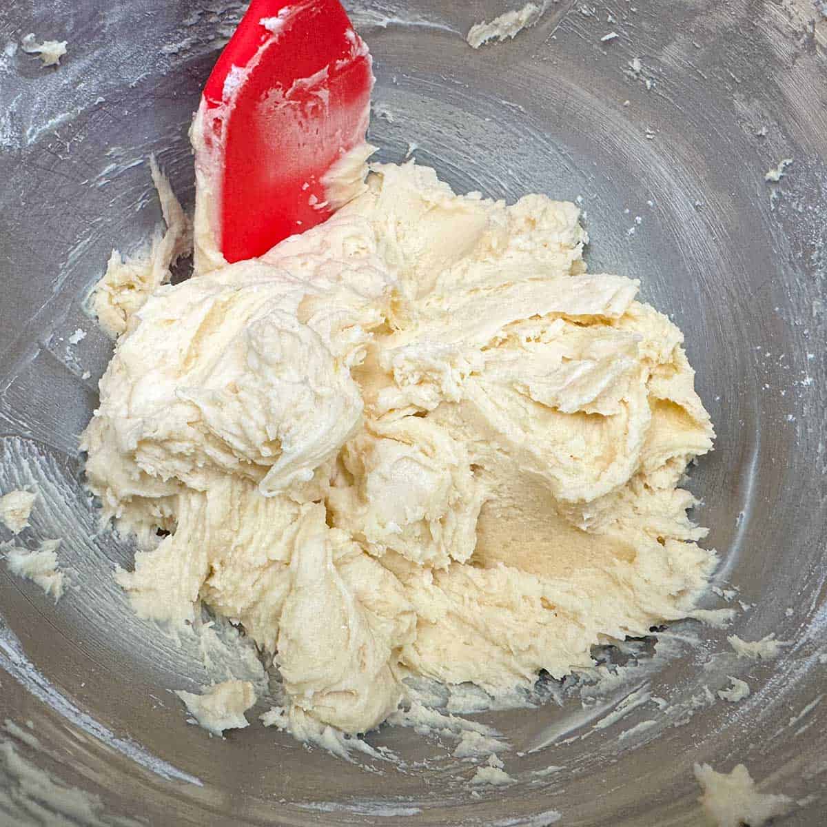 Flour mixture added to the wet ingredients in the mixer bowl.