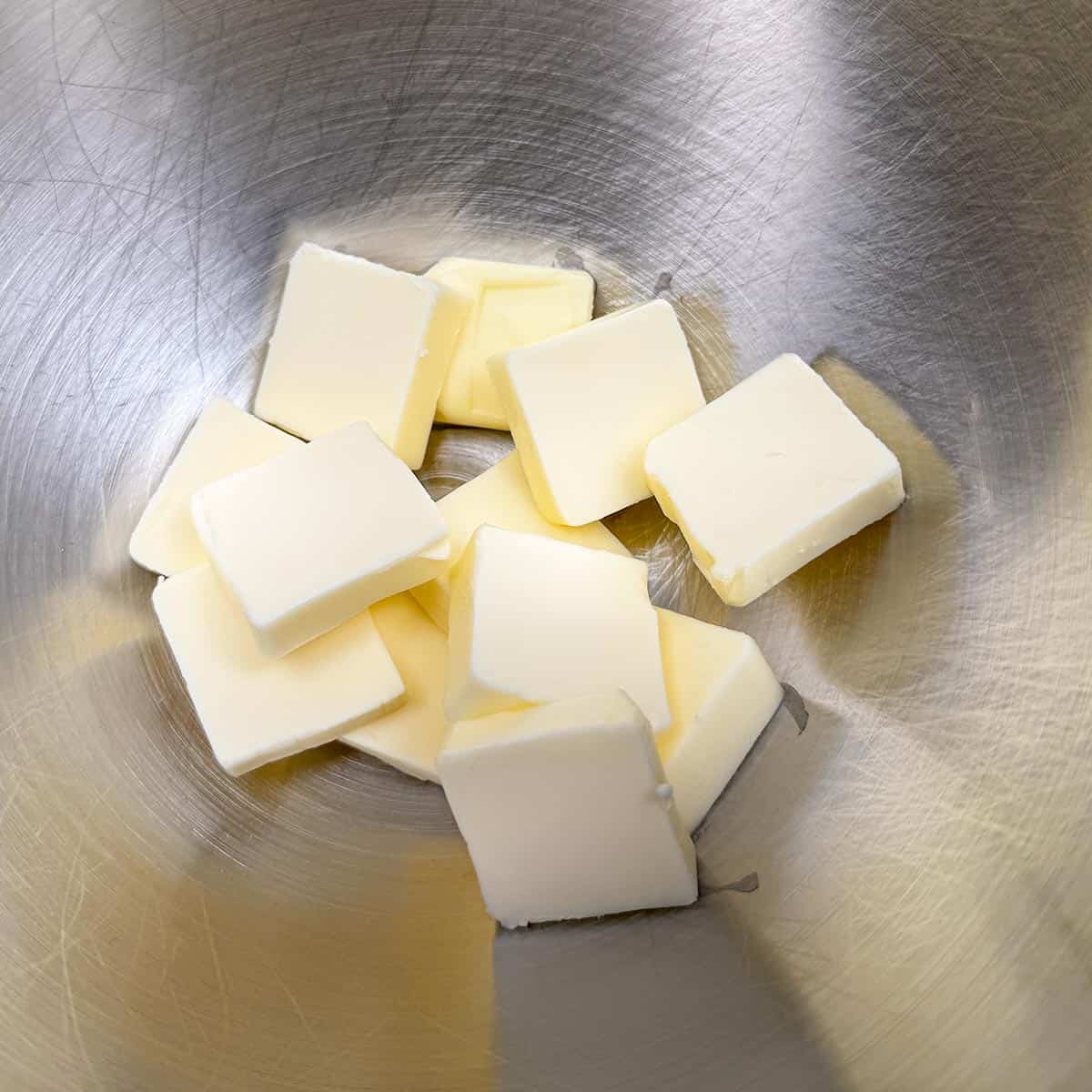 Cubed butter in a mixer bowl.