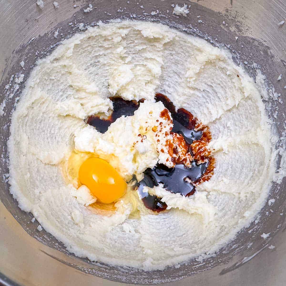 Adding the molasses, egg and water to the butter-sugar mixture.