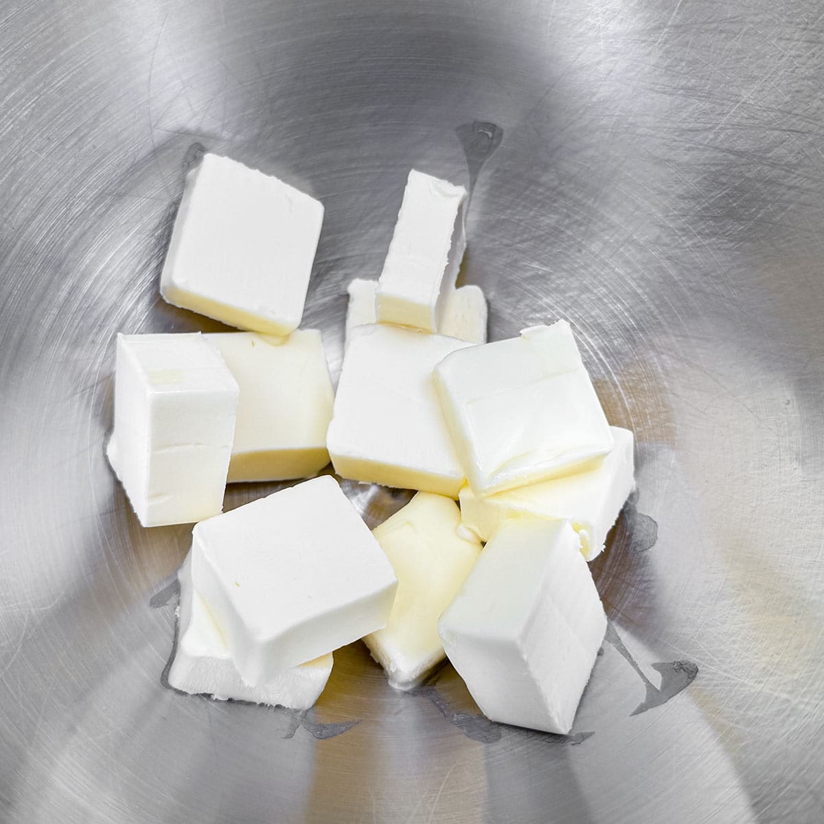 Cubed butter in a mixer bowl.