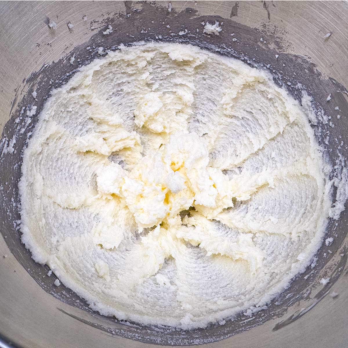 Butter and sugar that has been mixed for three minutes which is still a little grainy.