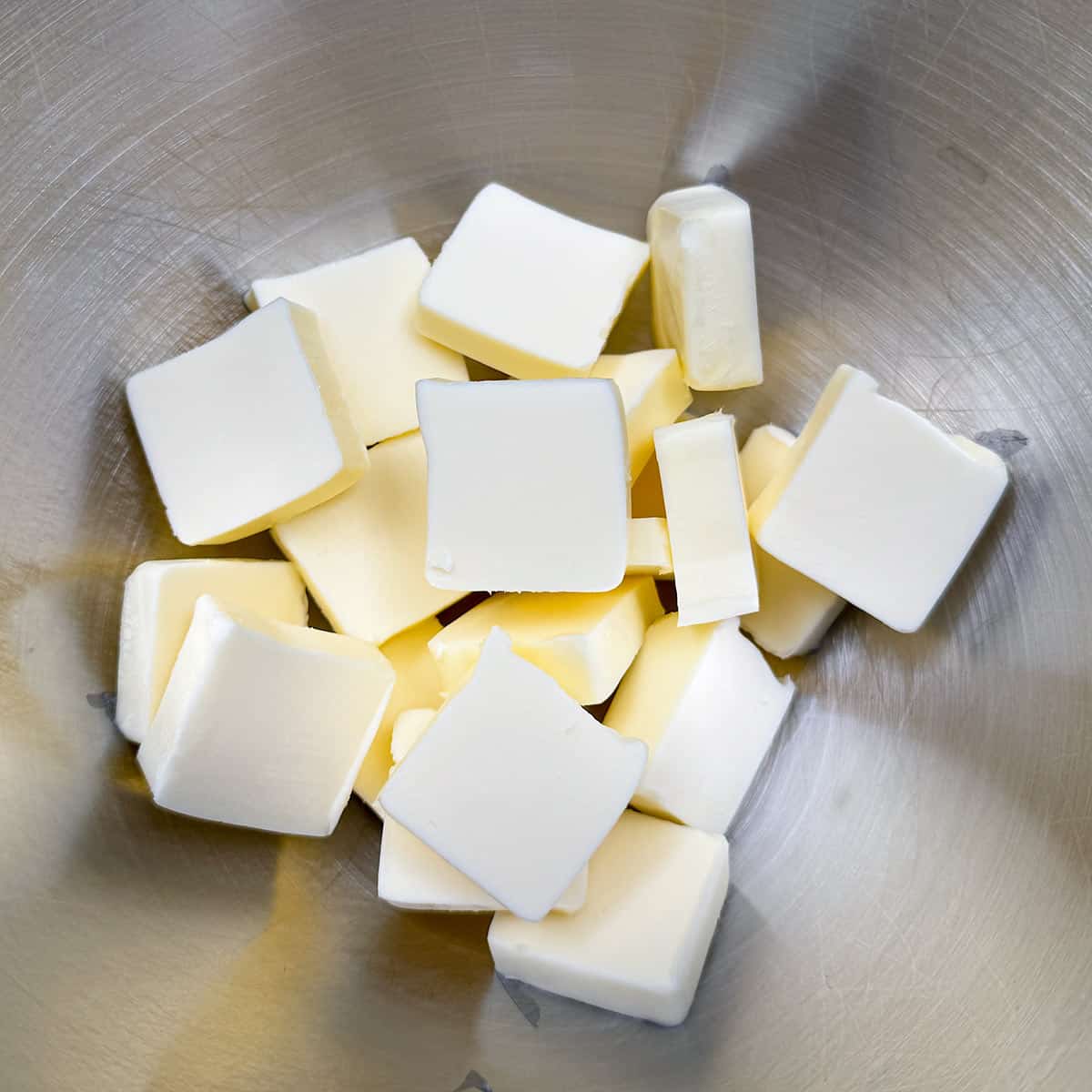 Cubed butter in a mixer bowl.