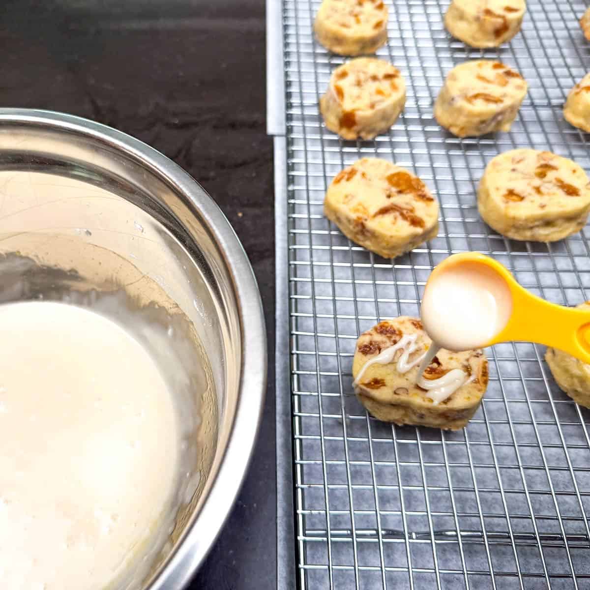 Taking the honey orange glaze and adding it to the top of the cookie.