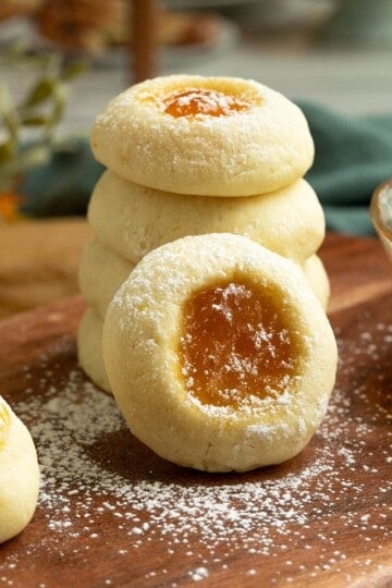 Apricot Cream Cheese Cookies stacked with powdered sugar sprinkled on top.