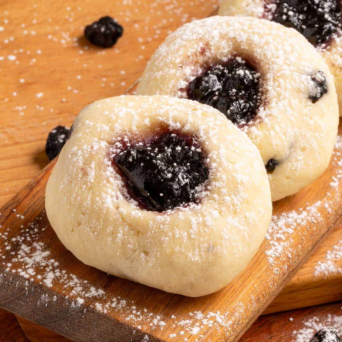 Blueberry cookie filled with blueberry preserves on a wooden board. 