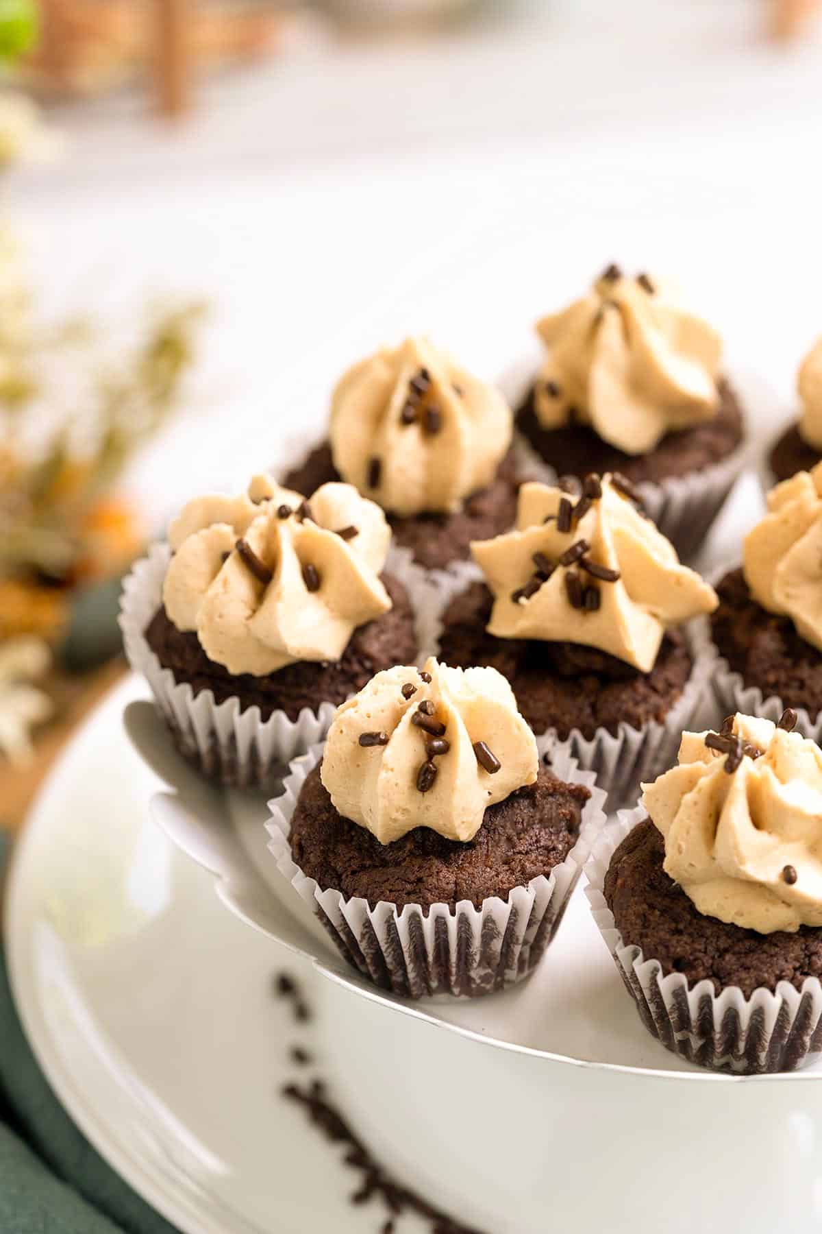 Chocolate cookie cupcakes with peanut butter frosting, sitting on a plate completed.