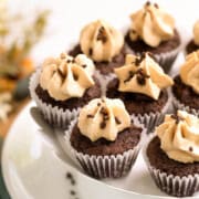 Close up of Chocolate cookie cupcakes with peanut butter frosting sitting on a plate.