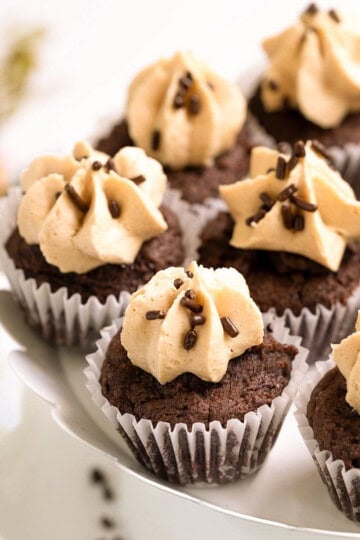 Close up of Chocolate cookie cupcakes with peanut butter frosting sitting on a plate.