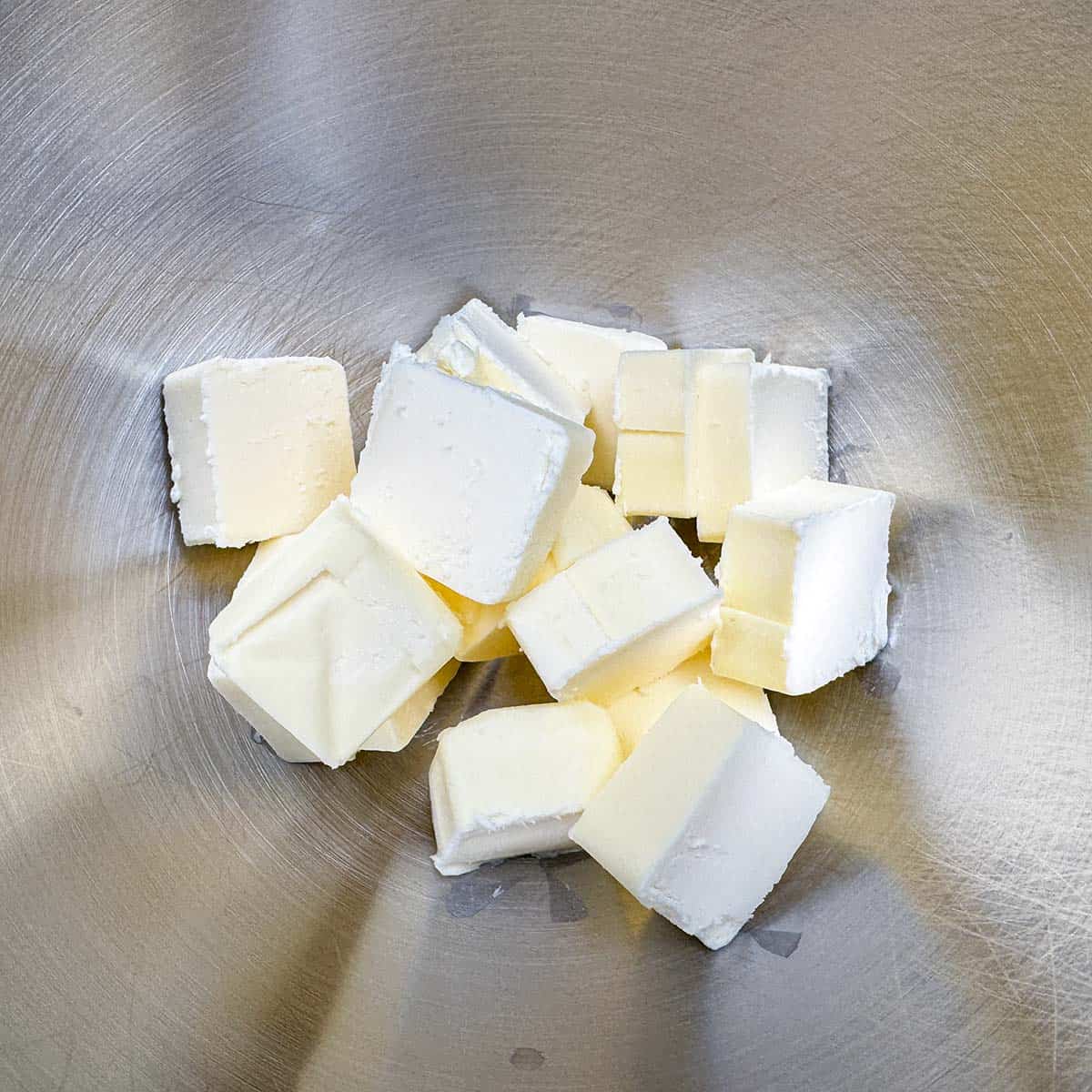 Cubed butter in a mixer bowl.