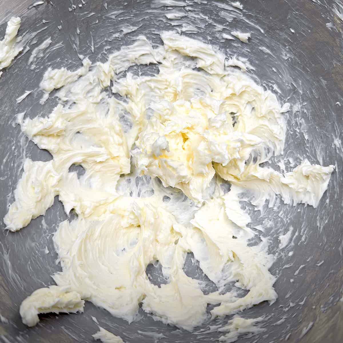 Creamed butter in a mixer bowl.