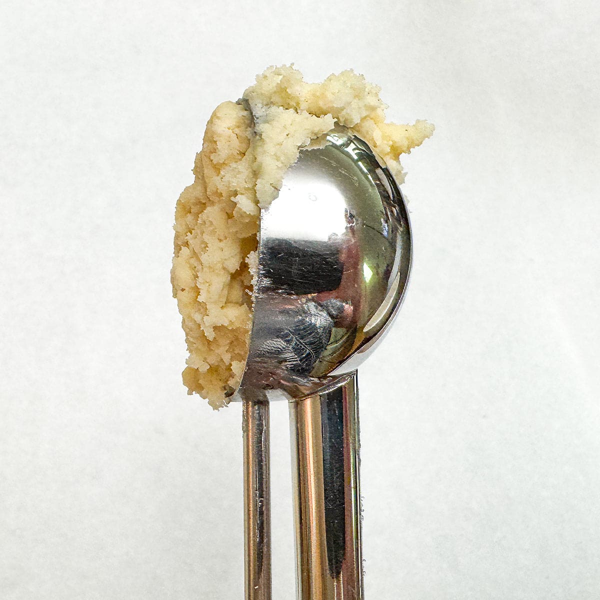 Scoop of cookie dough to show how much to roll.