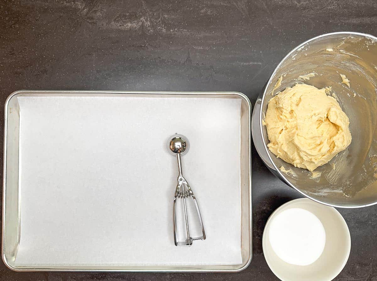 Setup for scooping and rolling cookie ball in sugar.