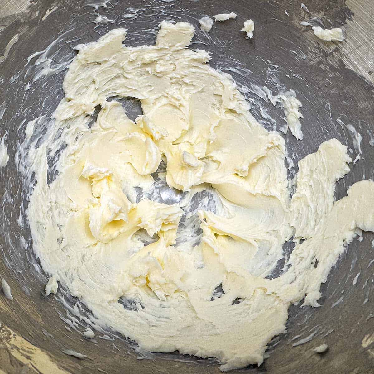 Creamed butter in a mixer bowl.