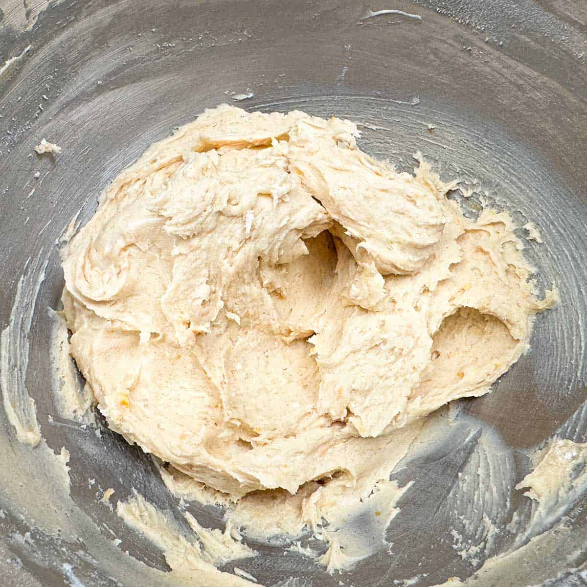 Cookie dough in a mixer bowl after the flour mixture has been blended in.